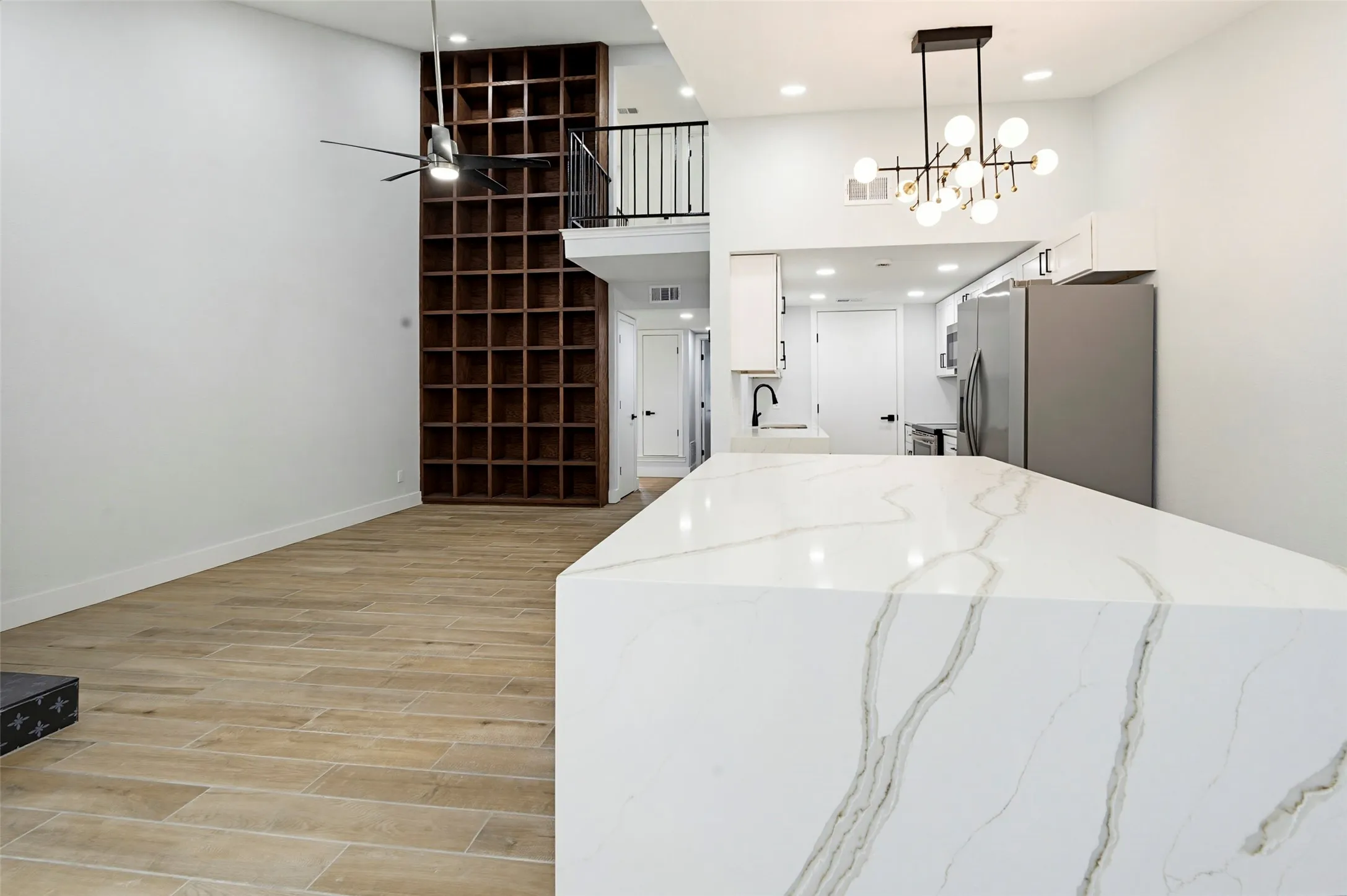 Open-concept living space with wood-finish flooring