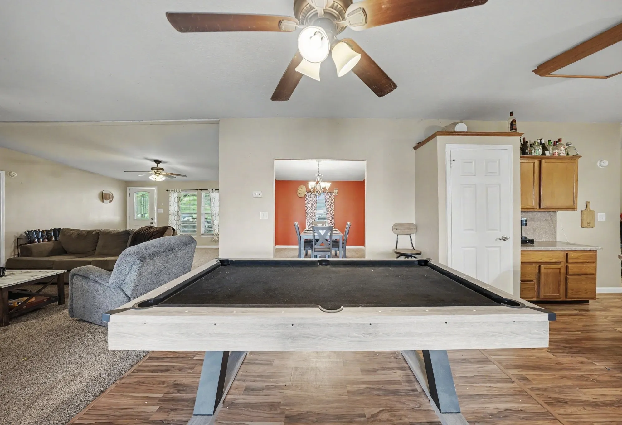 Flexible bonus space between the living room and kitchen, perfect for a game area, sitting area, or additional entertaining space.