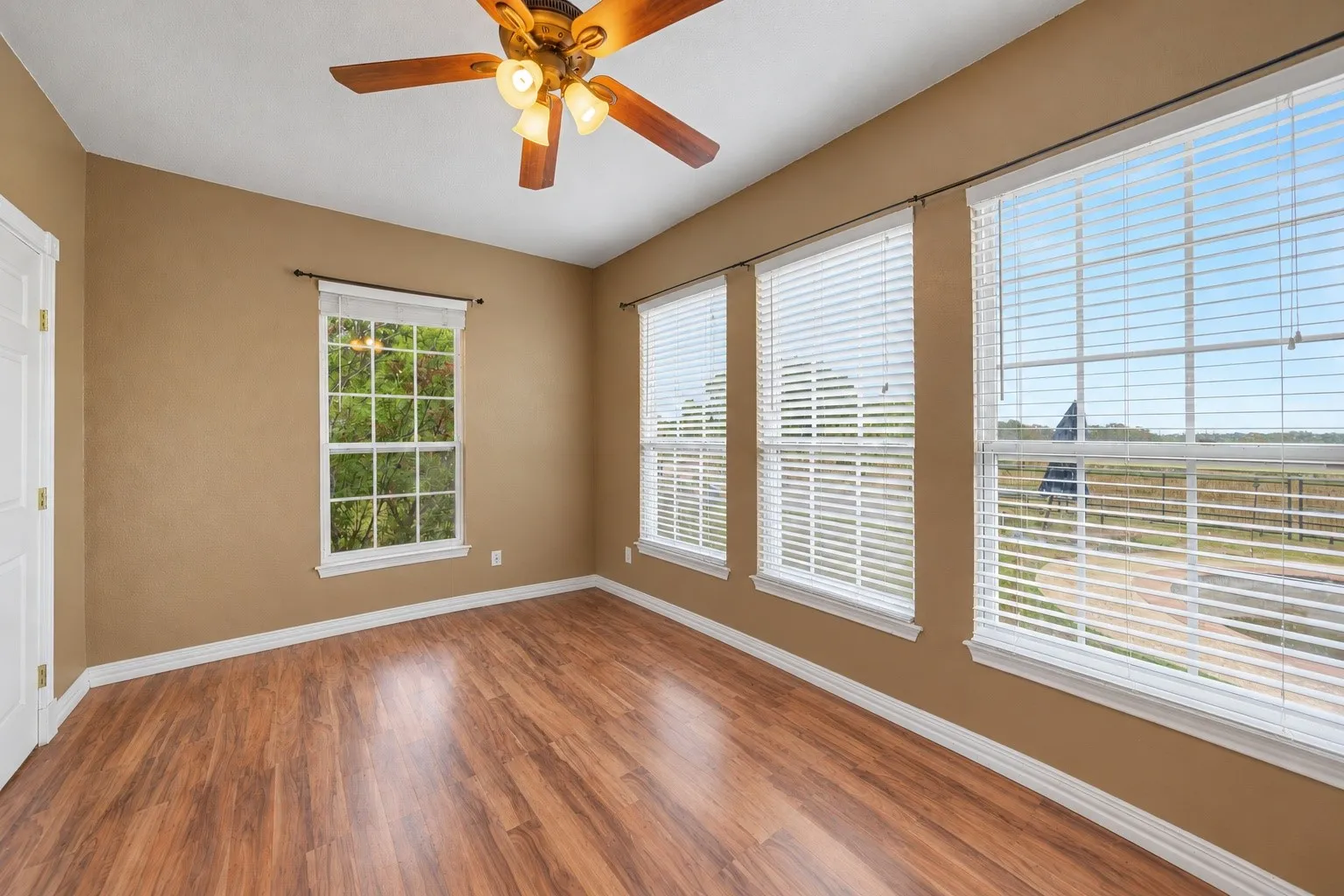 Spacious den with plenty of natural light, ideal for a media room, home library, or additional gathering space.
