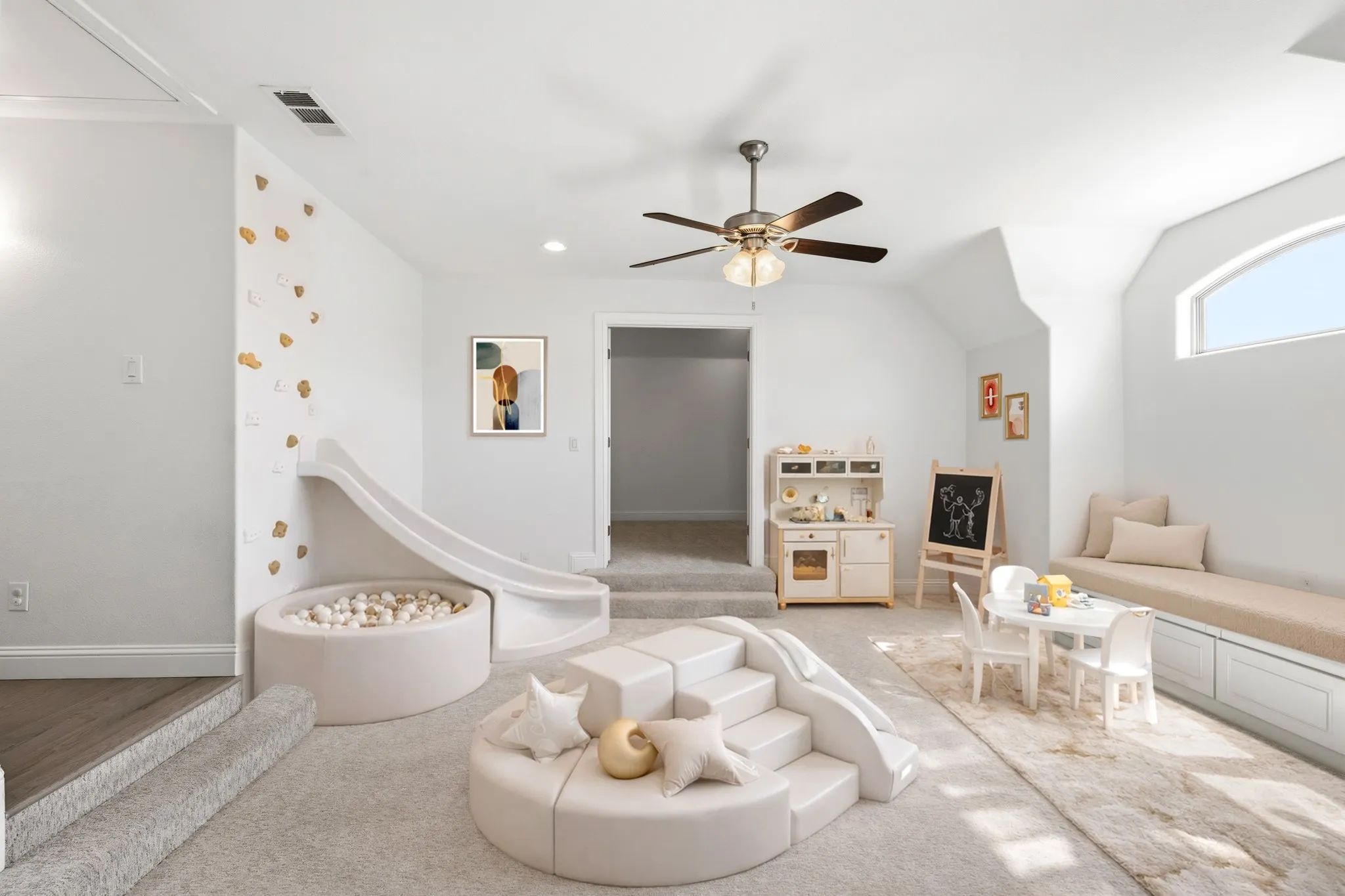 Recessed ceiling lighting, ceiling fan, arched window, built-in window bench with integrated storage, and carpeted flooring