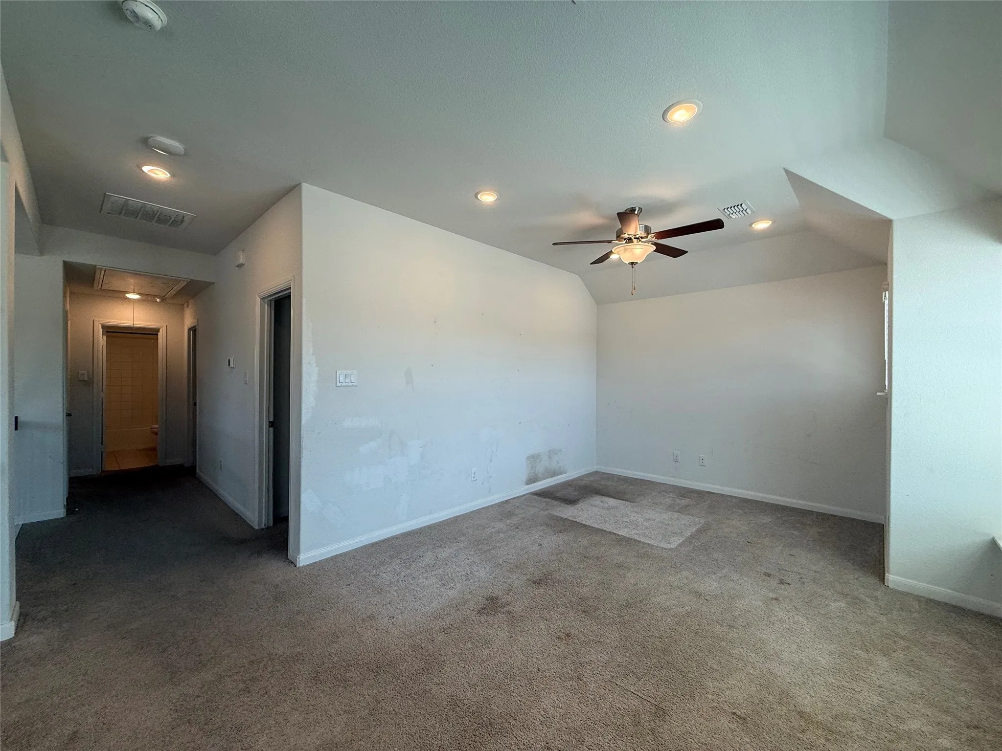 Recessed lighting, sloped ceiling, and ceiling fan