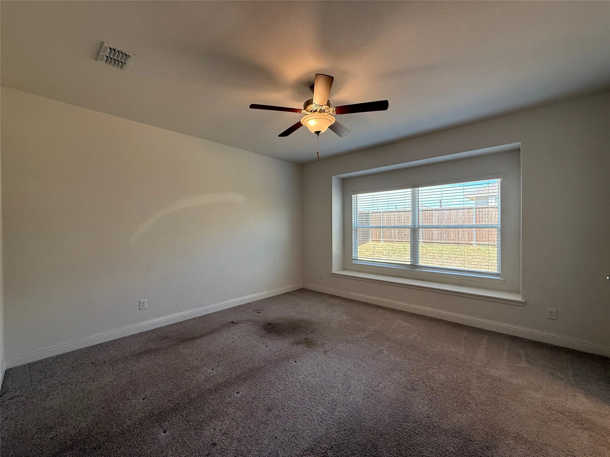 Recessed window with a deep sill, ceiling fan with light fixture, and neutral wall tones