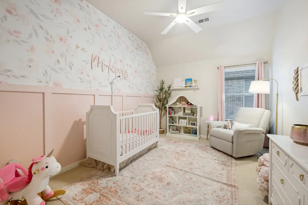 Pink room - Spacious secondary bedroom on the second floor featuring plush carpet, vaulted ceilings, a large closet, and abundant natural light, offering a comfortable retreat for family or guests.