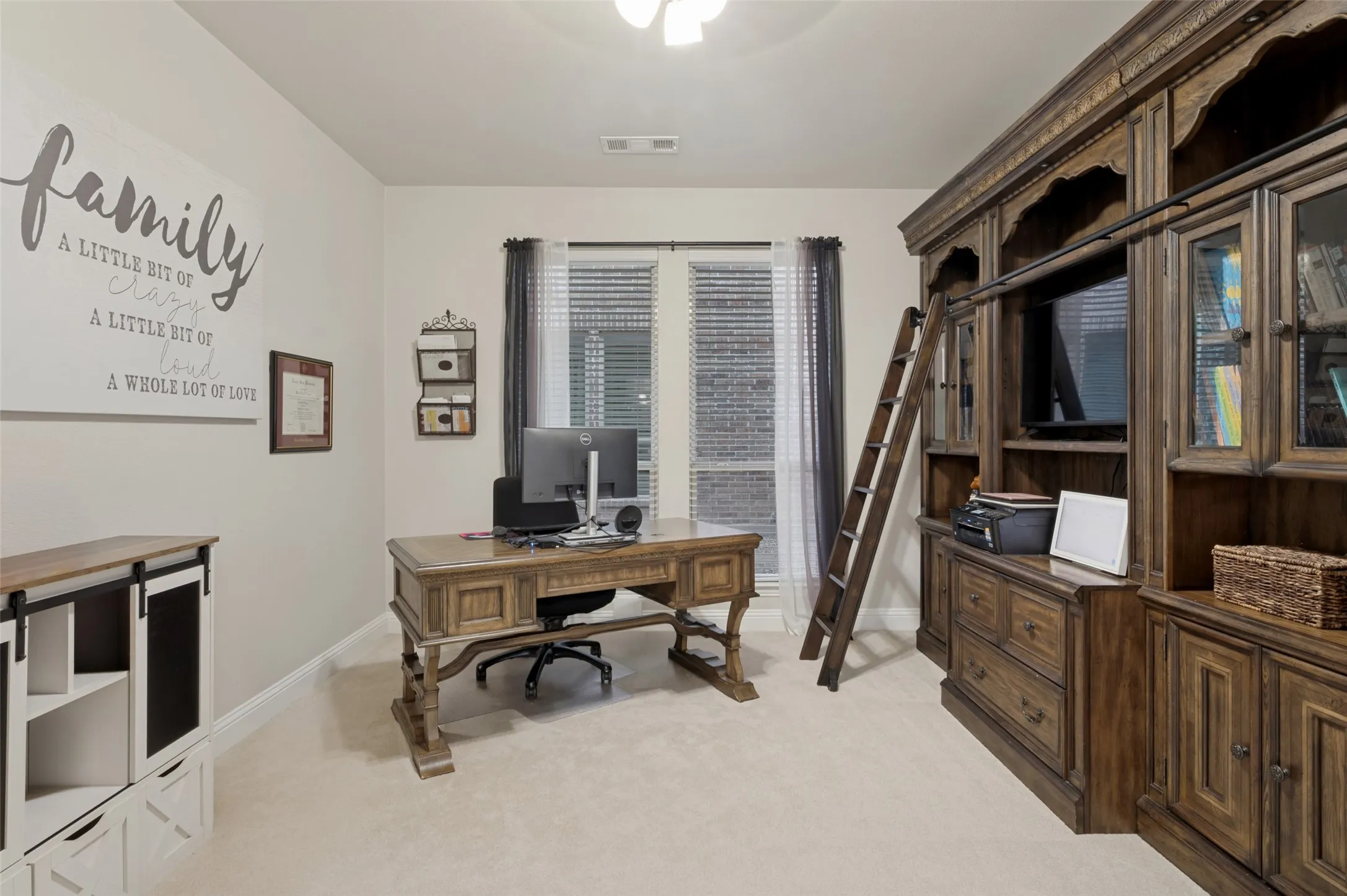 Dedicated home office with glass French doors, large windows for abundant natural light, and a quiet, private setting that's ideal for working from home, studying, or managing everyday tasks.