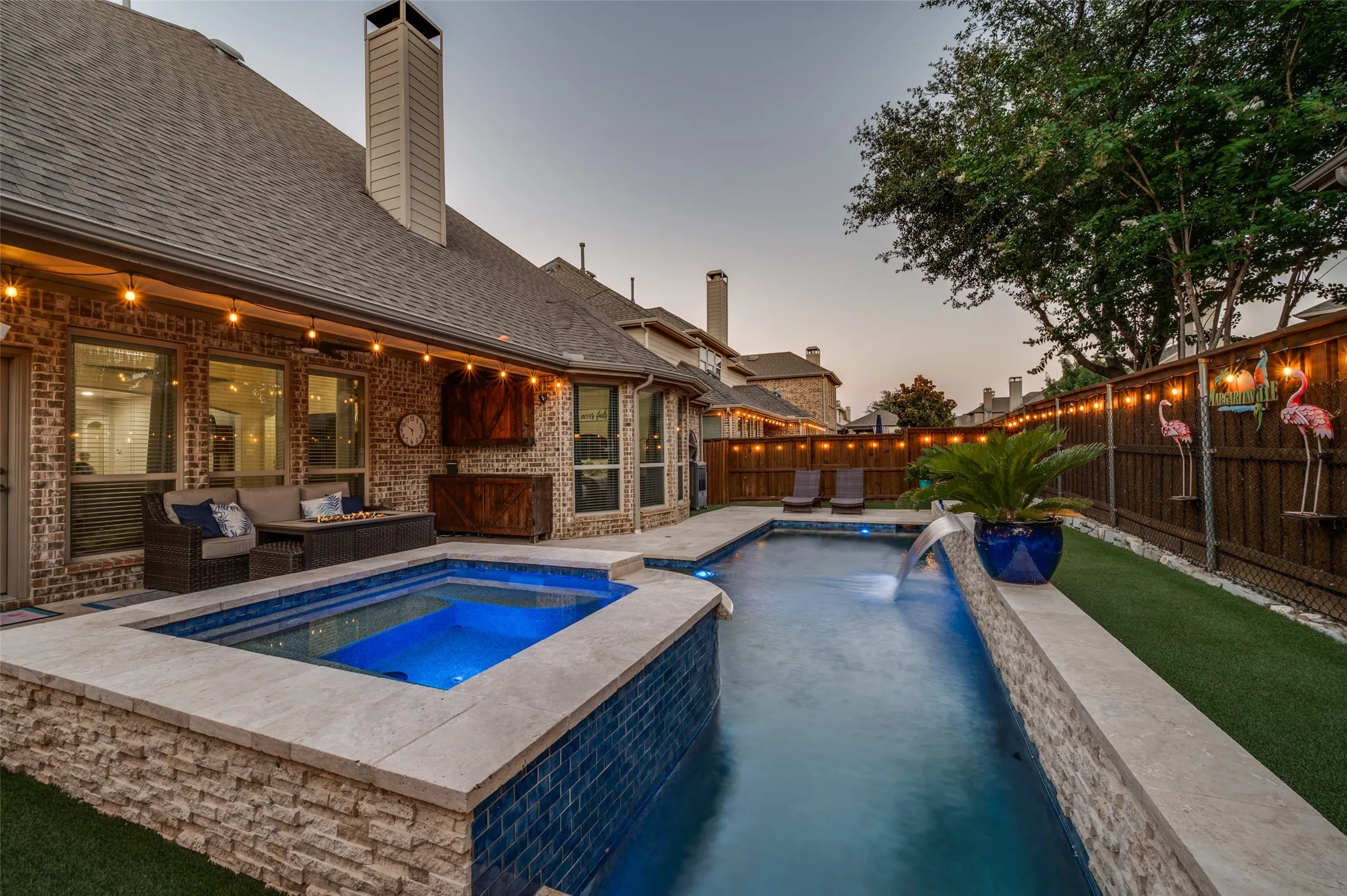 Welcome to 3108 Stonefield, where a backyard oasis awaits with a sparkling pool and raised spa, tranquil water features, and an expansive covered patio. Low-maintenance turf, string lighting, and privacy fencing create the perfect setting for relaxing, entertaining, and enjoying year-round outdoor living.