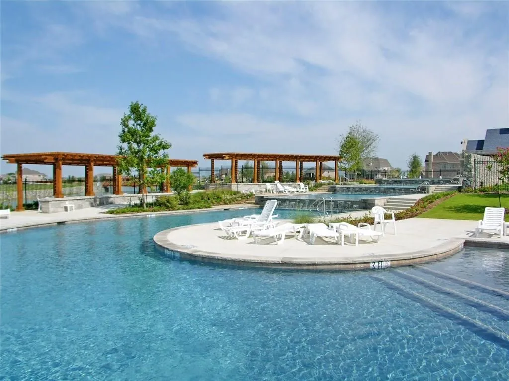 Enjoy access to a second resort-style neighborhood pool, beautifully positioned along one of The Tribute's scenic canals. Featuring expansive sun decks, lounging areas, shaded pergolas, and sparkling water views, this tranquil retreat offers the perfect place to relax, unwind, and enjoy the community's exceptional lakeside lifestyle. ...
...