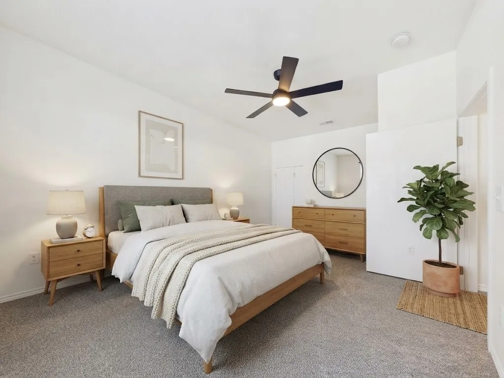 Carpeted flooring, vaulted ceiling, and a ceiling fan with integrated lighting