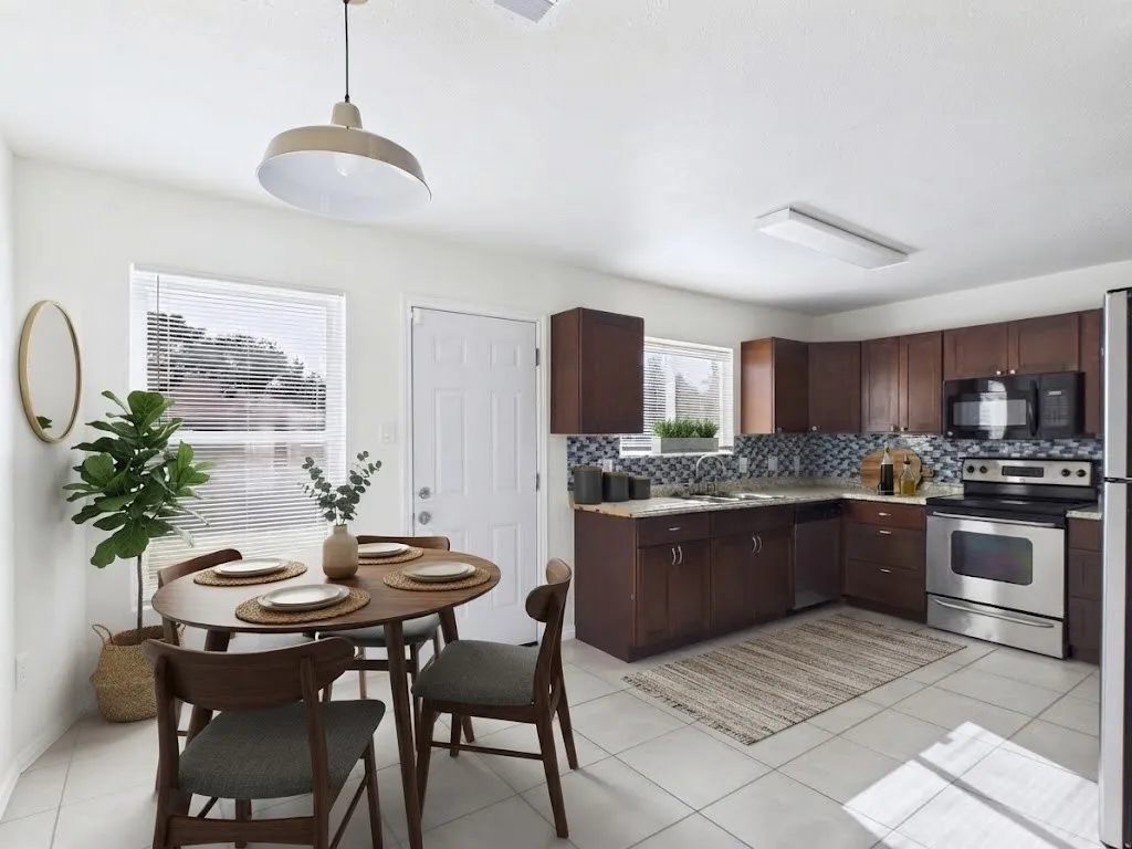 Kitchen with wood-finish cabinetry, stainless steel appliances, and a mosaic tile backsplash