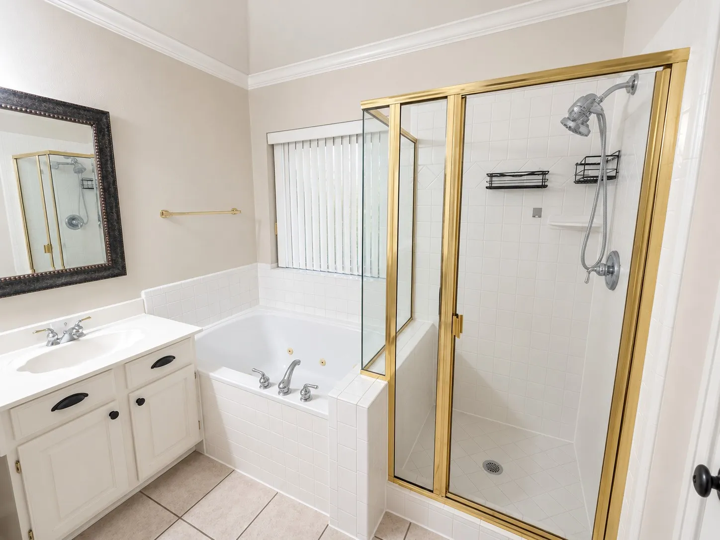 White vanity with an integrated sink, polished chrome faucet, and black hardware