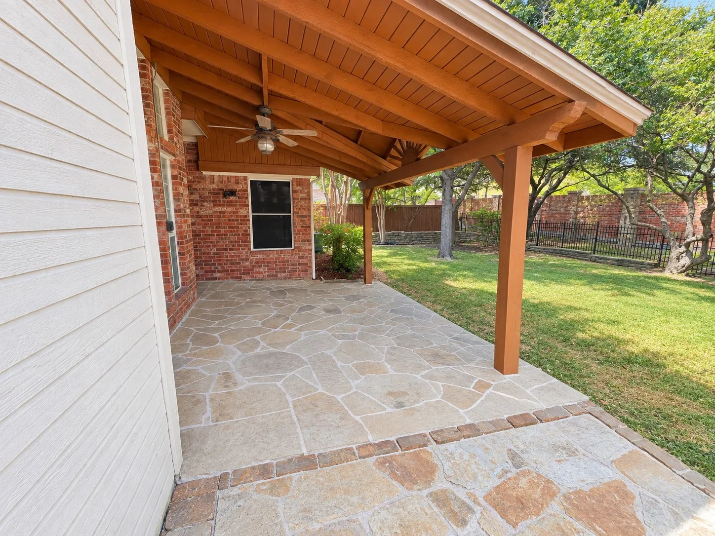 Covered patio with a wood-finish ceiling and a ceiling fan