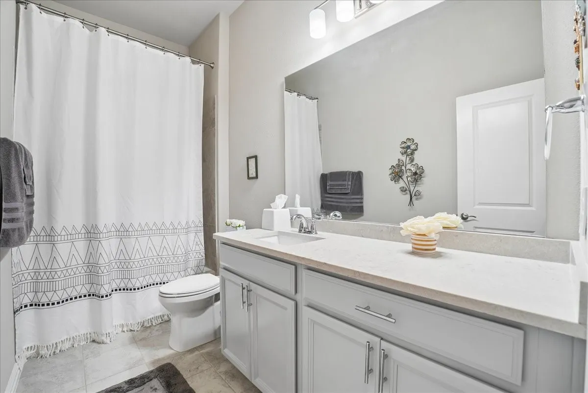 Third full bath conveniently located between the third and fourth secondary bedrooms.