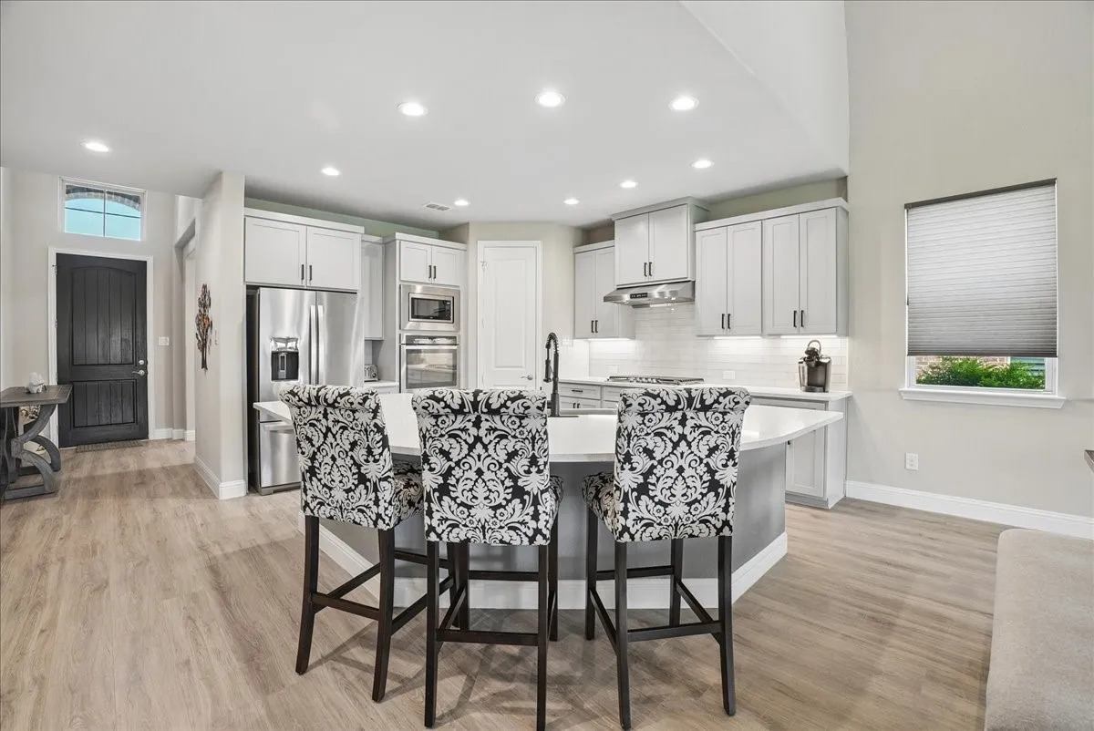 Large island overlooking beautifully remodeled kitchen.