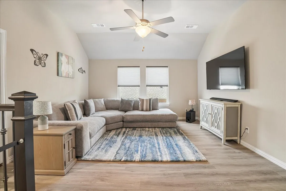 Spacious upstairs game room perfect for relaxing and entertaining.