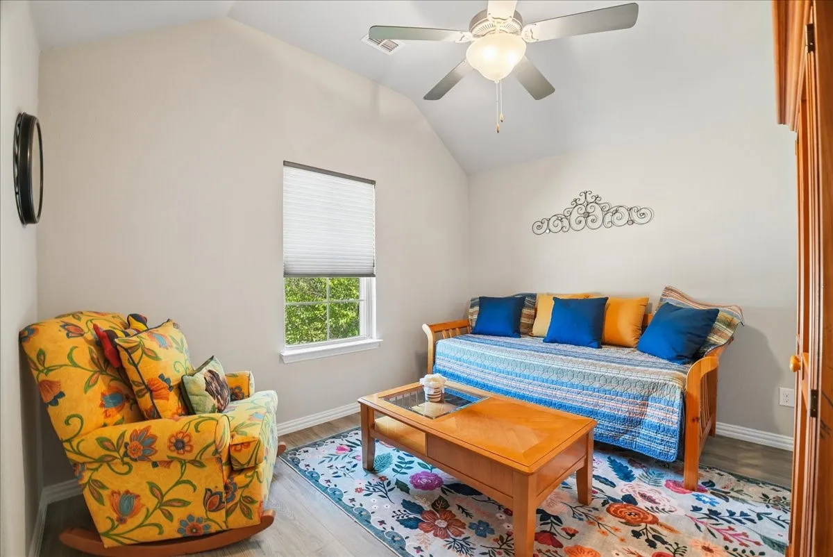 Bright fourth secondary bedroom with vaulted ceiling and abundant natural light.