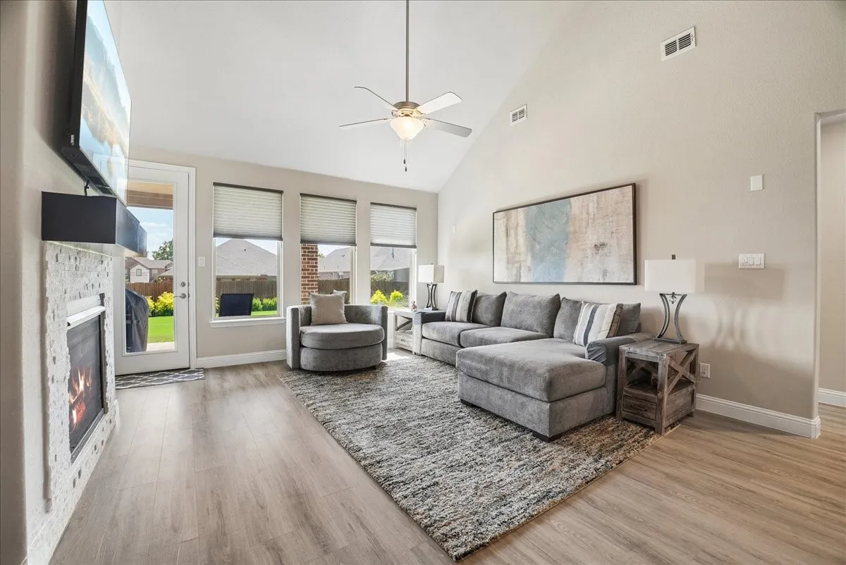 Abundant space and light in the vaulted living room with beautiful views of the lush backyard.
