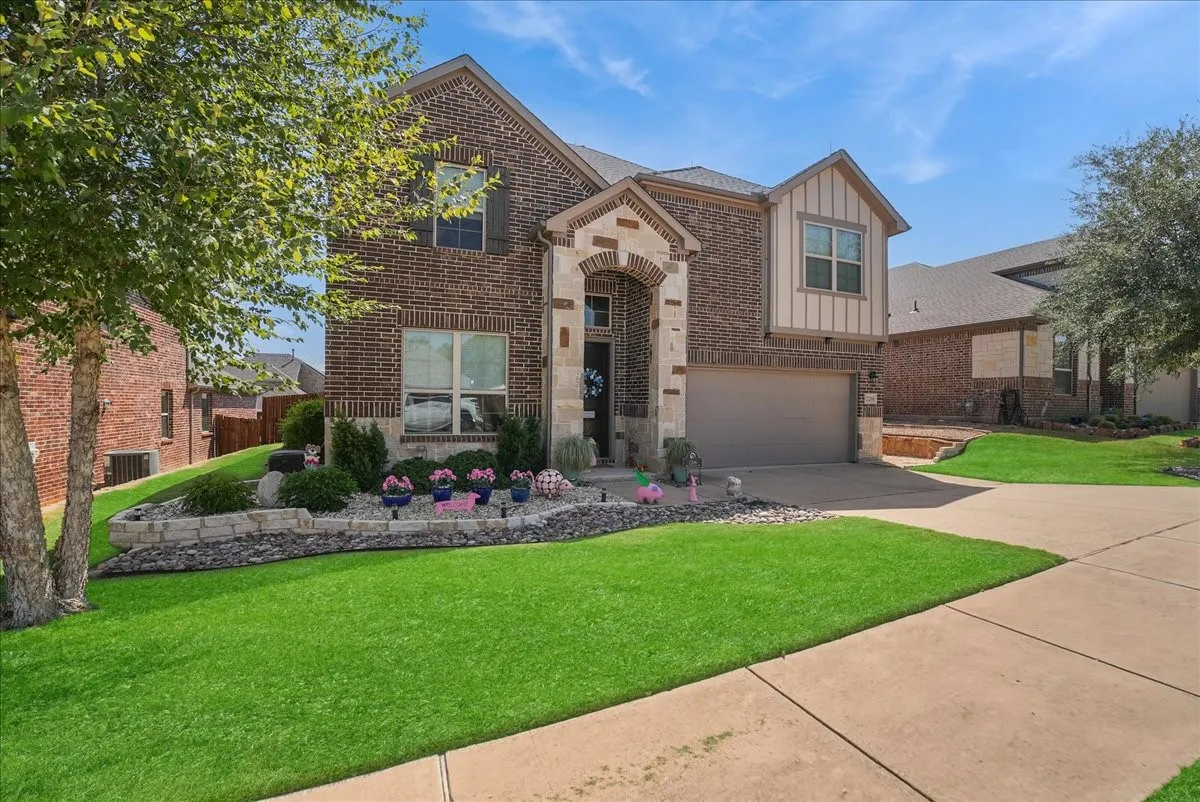 Beautiful curb appeal enhanced by decorative stonework, river rock and landscaped flower beds.
