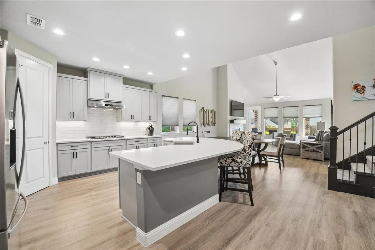 Beautifully remodeled kitchen with large island, abundant cabinetry and open-concept living.
