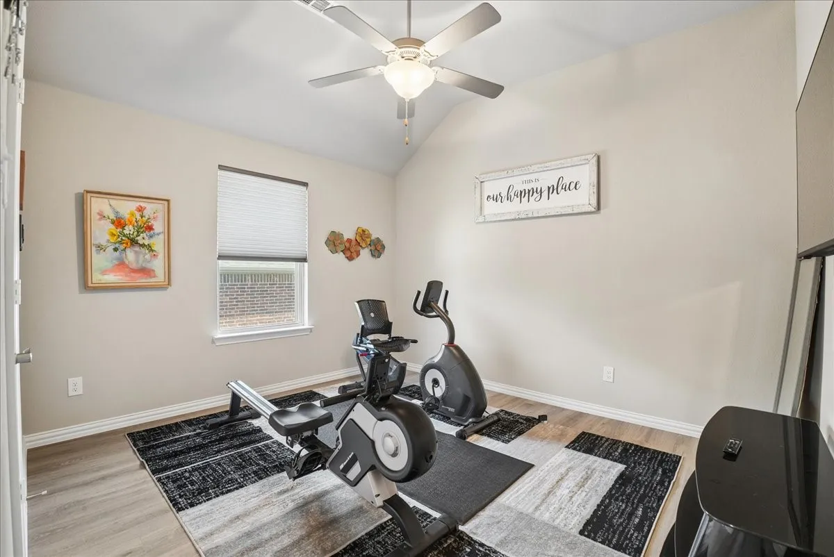 Versatile secondary bedroom currently used as a home exercise room.