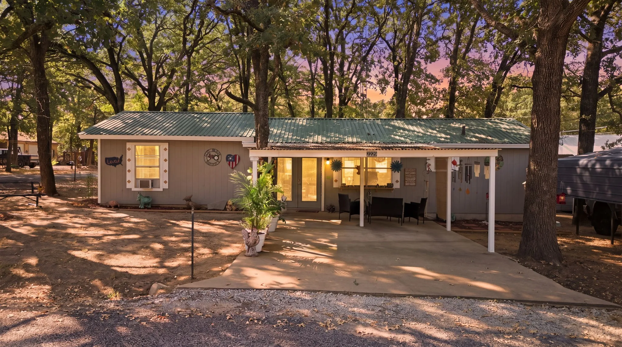 Single-story residence featuring a metal roof, covered patio, and attached carport
