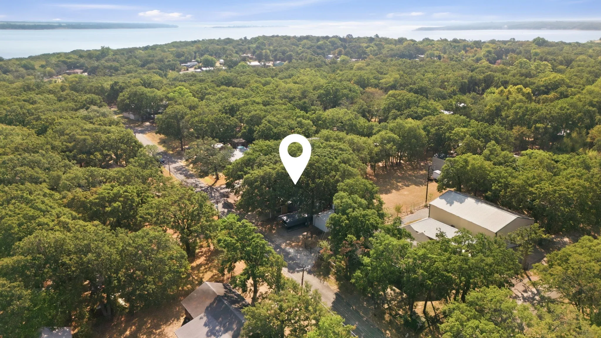 Expansive natural surroundings with mature trees and a substantial water body