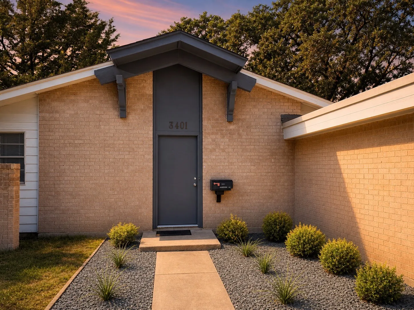Brick exterior with a contemporary gray entry door