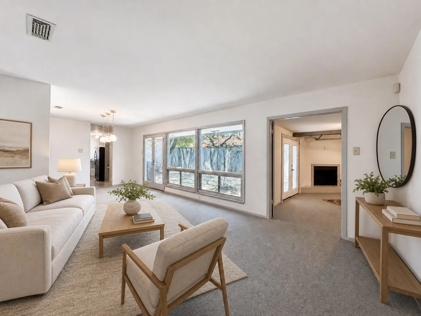 Living space with large windows, light gray carpeting, and a built-in fireplace