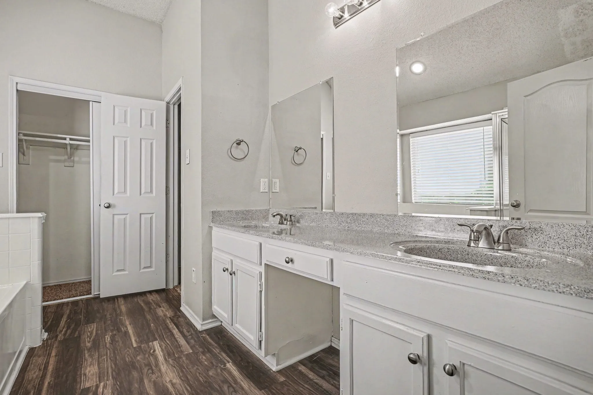En-suite primary bath featuring dual sink vanity; garden tub, separate shower, 2 closets.