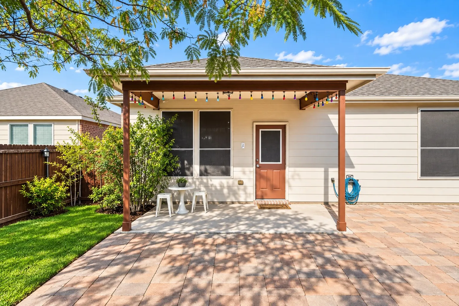Expansive paver patio with a covered pergola