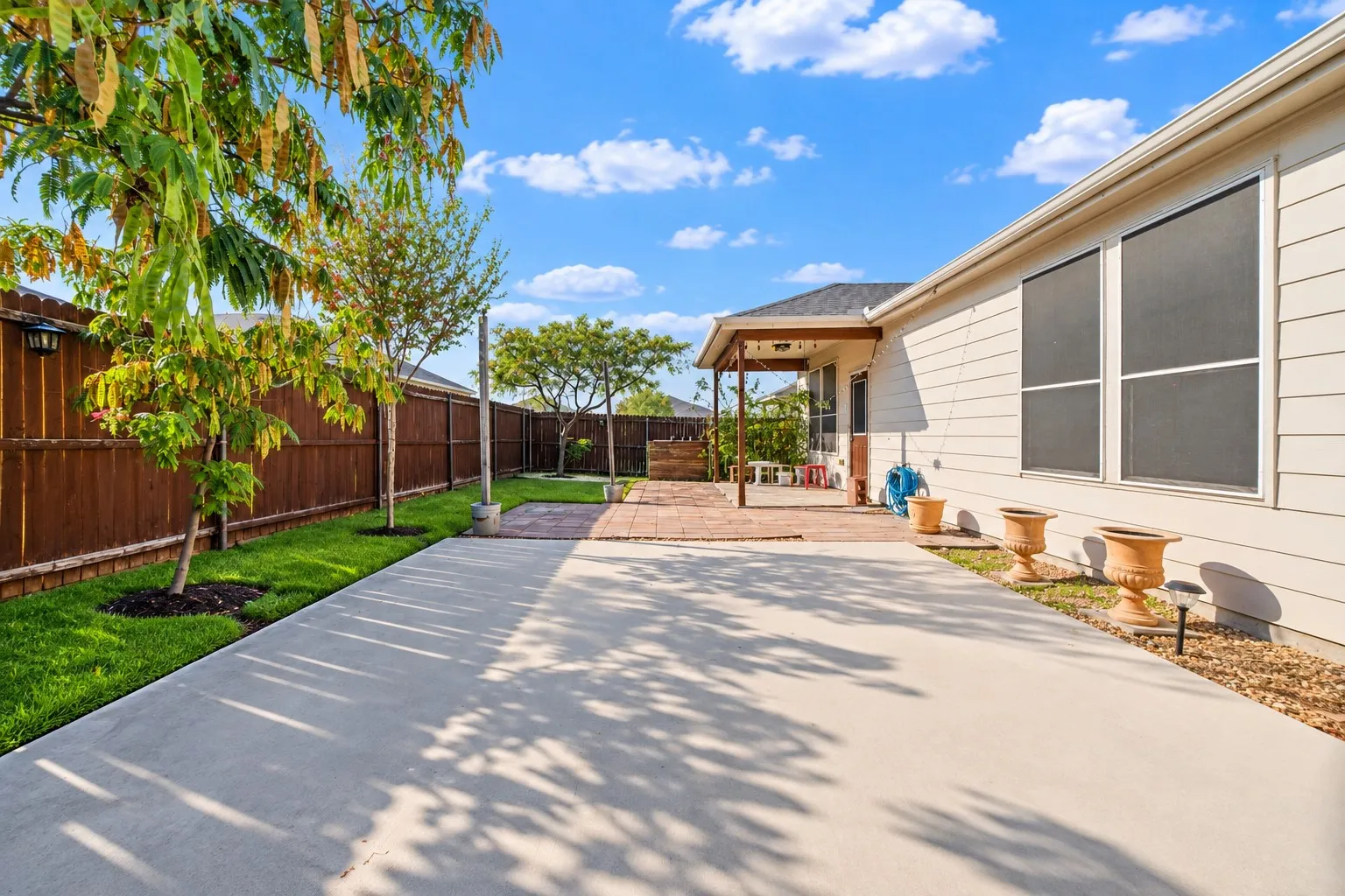 Expansive concrete patio with a covered outdoor area