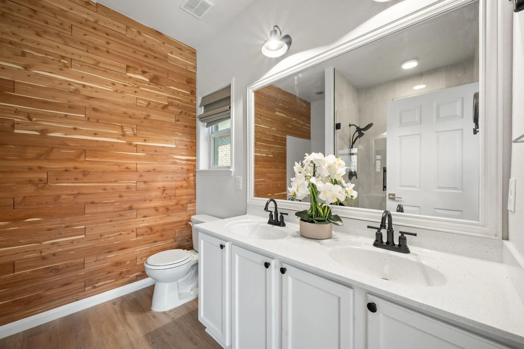 Dual vanity with integrated sinks, white cabinetry, and matte black fixtures