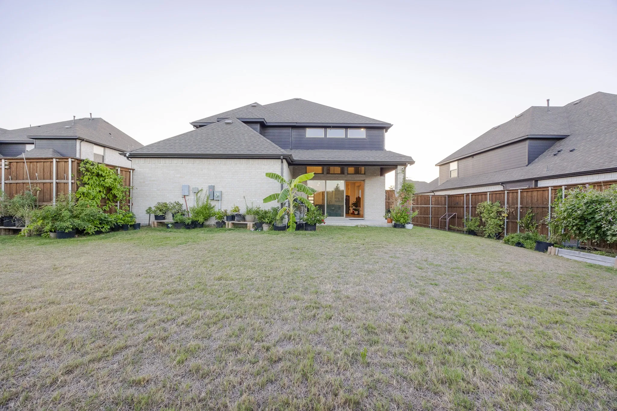 Expansive lawn area with a perimeter wood fence