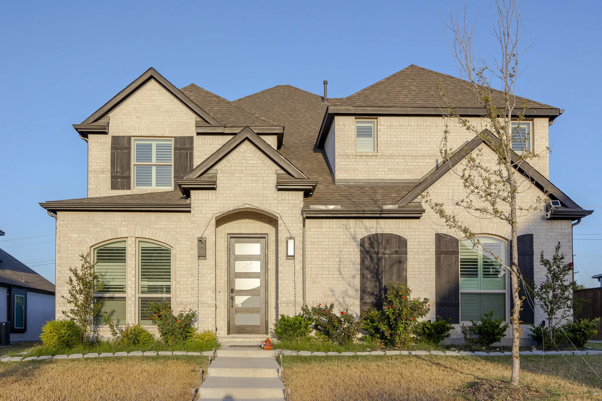 Two-story brick exterior with gabled roof lines
