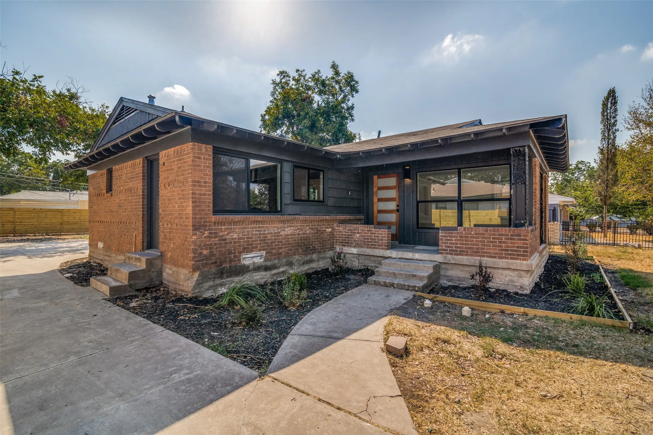 Brick and siding exterior with dark trim accents
