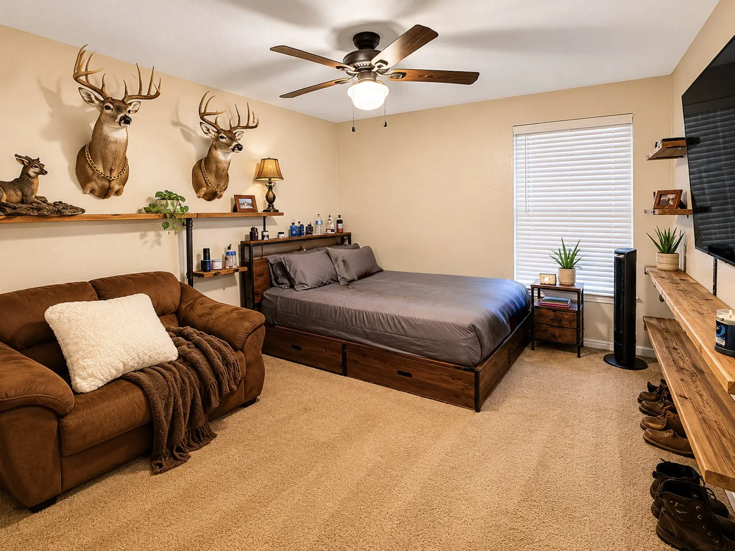 Wall-to-wall carpeting, window with blinds, ceiling fan, and wall-mounted shelving