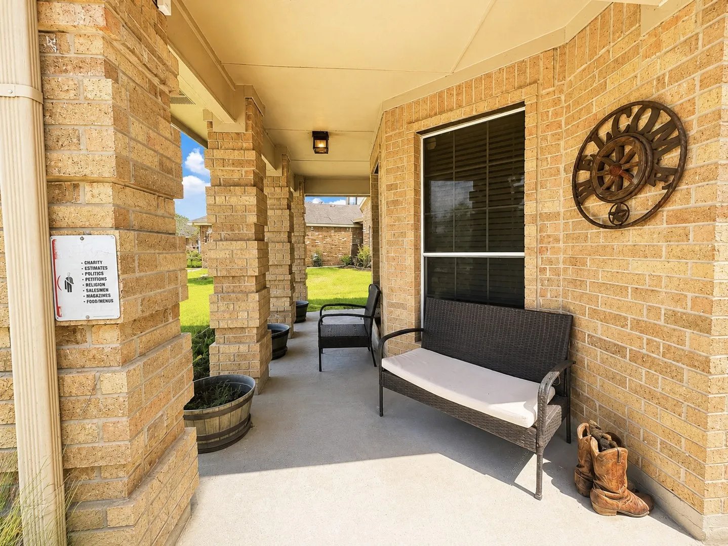 Covered outdoor patio with brick columns and a concrete surface