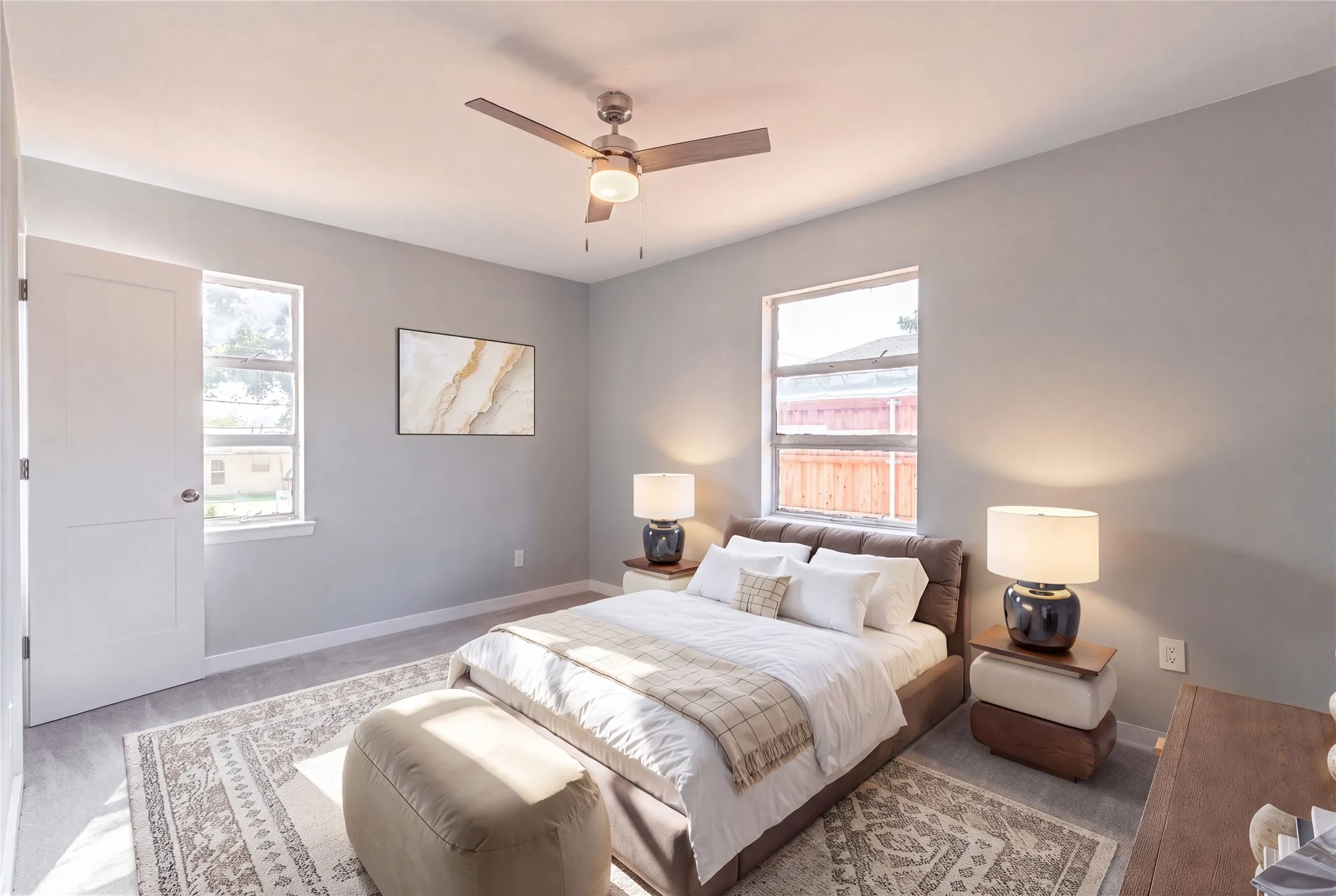Ceiling fan with integrated lighting, two panel doors, and two windows
