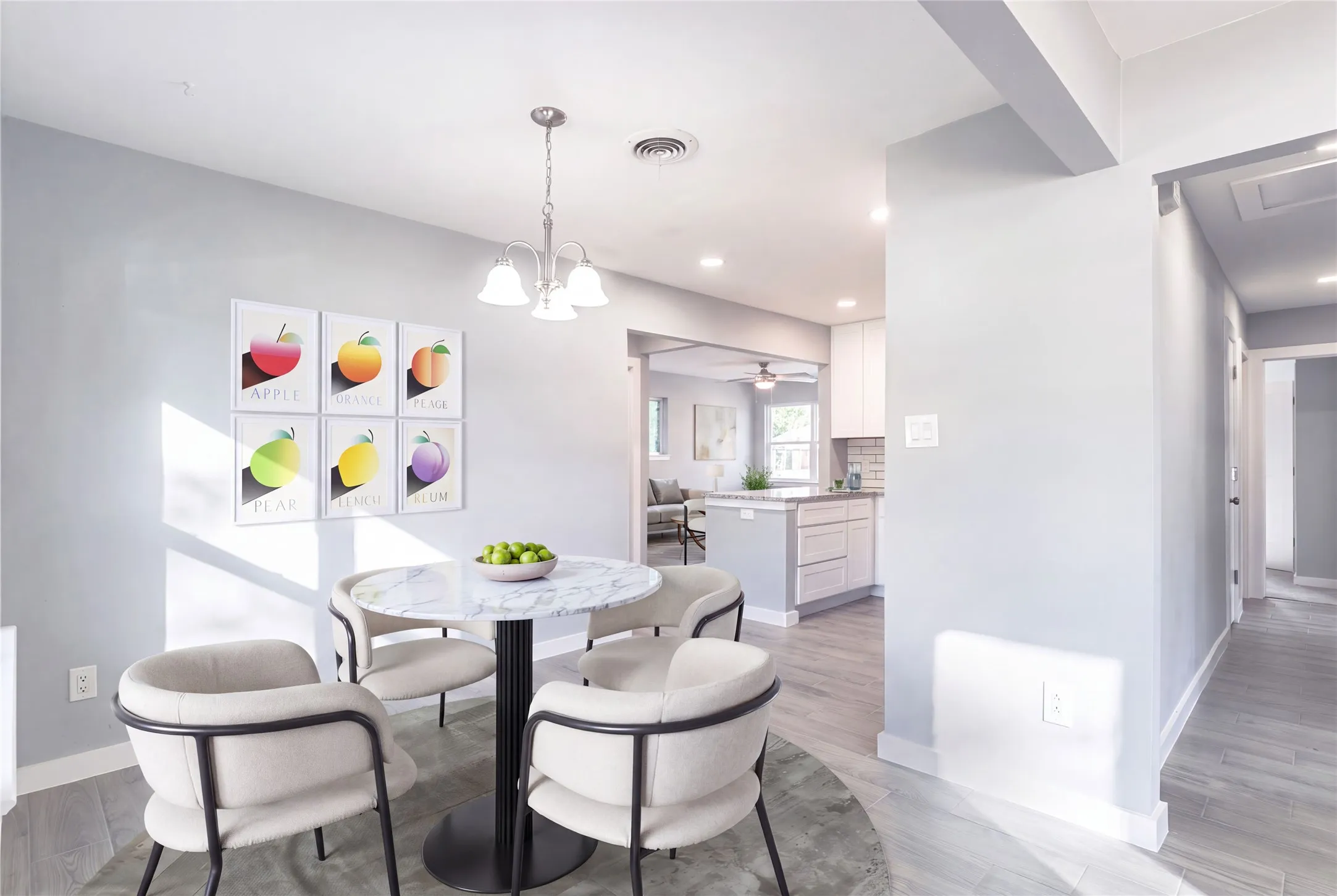 Dining area with wood-finish flooring and a contemporary chandelier