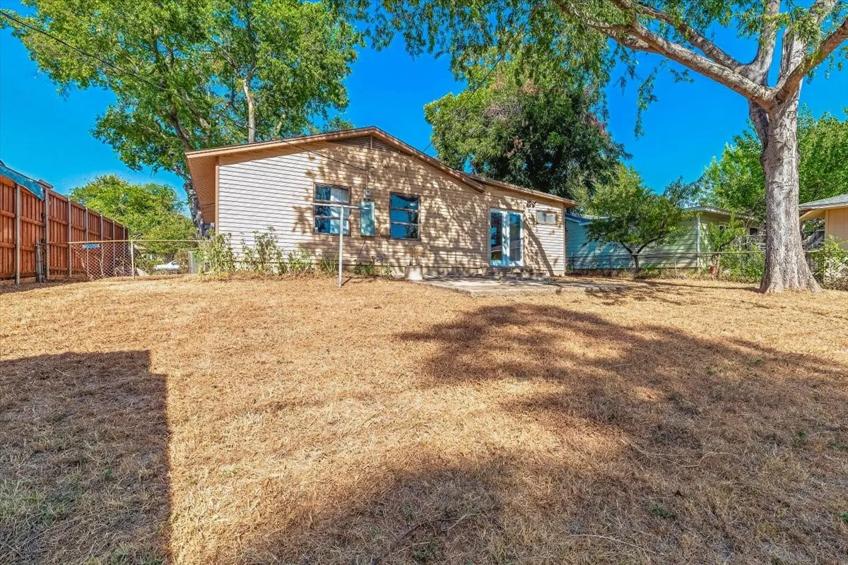 Rear exterior featuring horizontal siding, glass paneled doors, and a concrete patio