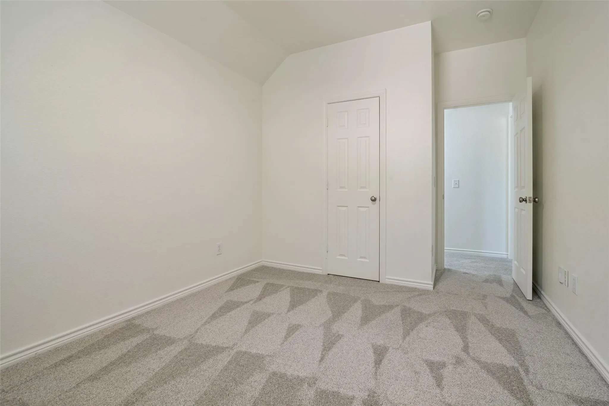 Geometric pattern carpet, white walls, white trim, panel doors, and recessed​​‌​​​​‌​​‌‌​‌‌​​​‌‌​‌​‌​‌​​​‌​​ lighting