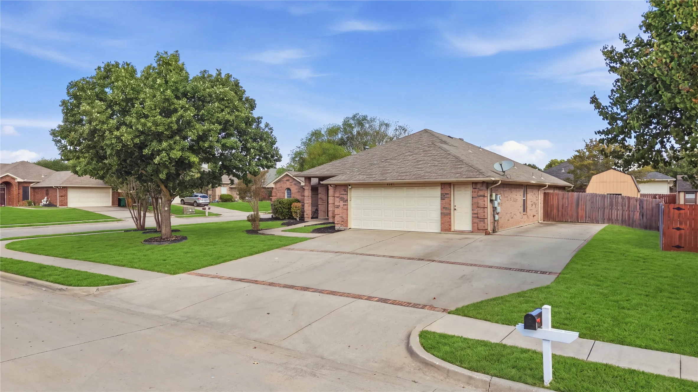 Brick exterior with an attached two-car garage, concrete driveway, and a  fenced yard. Also RV parking with all hookups including Sewer!