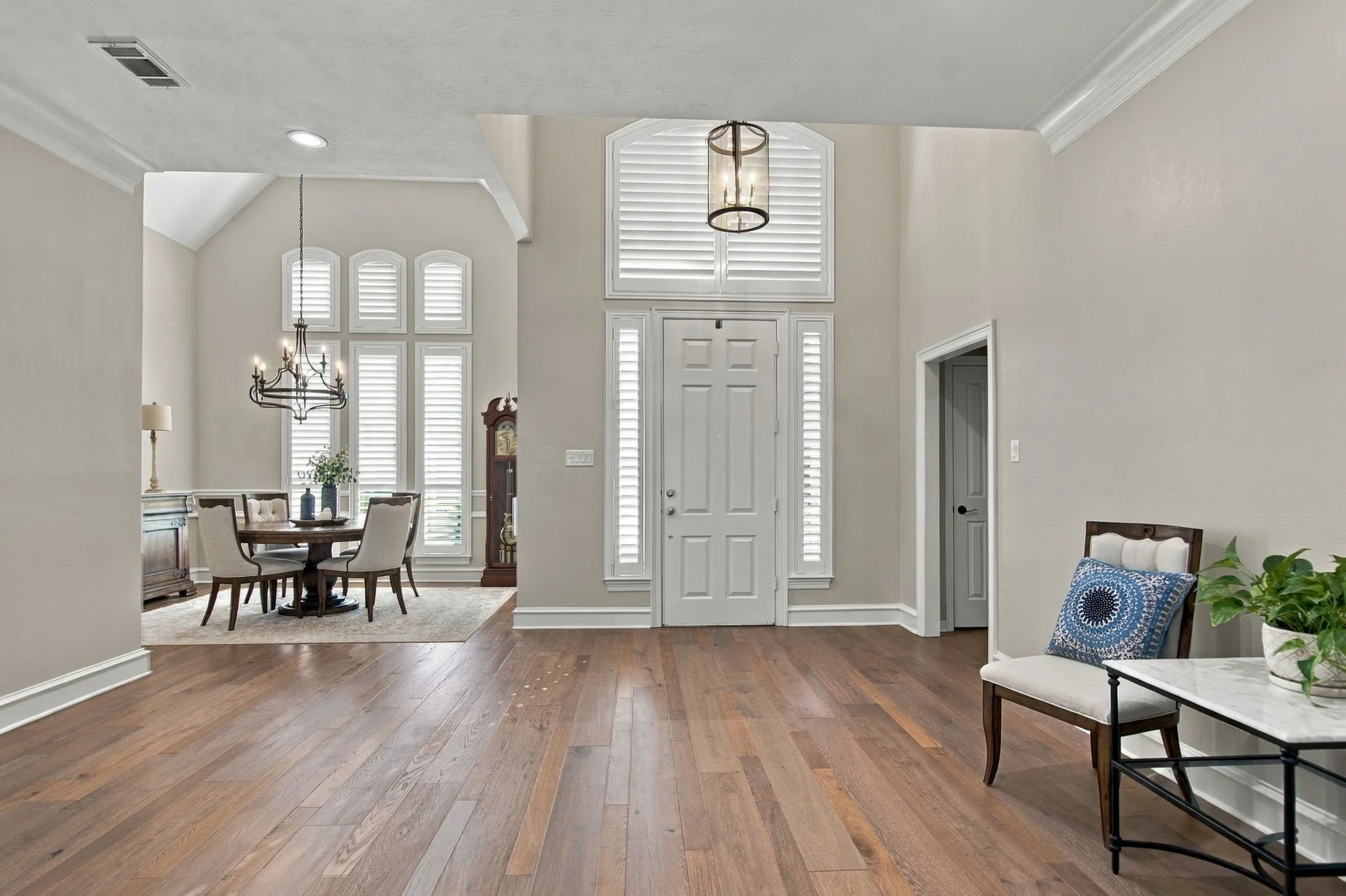 Entry opens to the living area featuring warm hardwood flooring throughout.