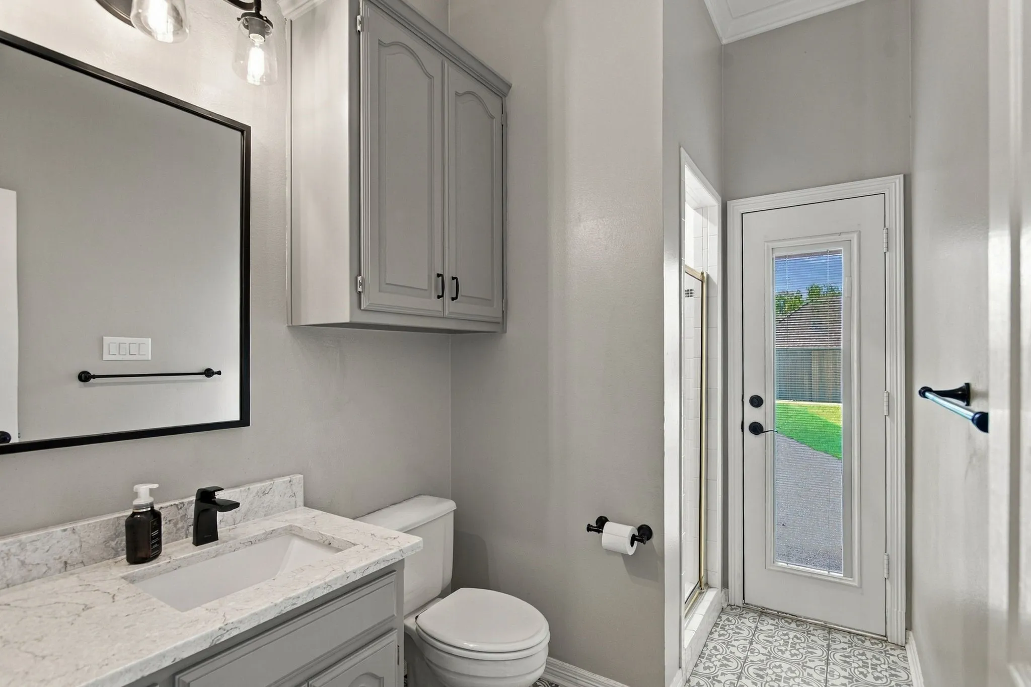 Downstairs bathroom with shower serves the guest bedroom with an outside entrance as the pool bath.