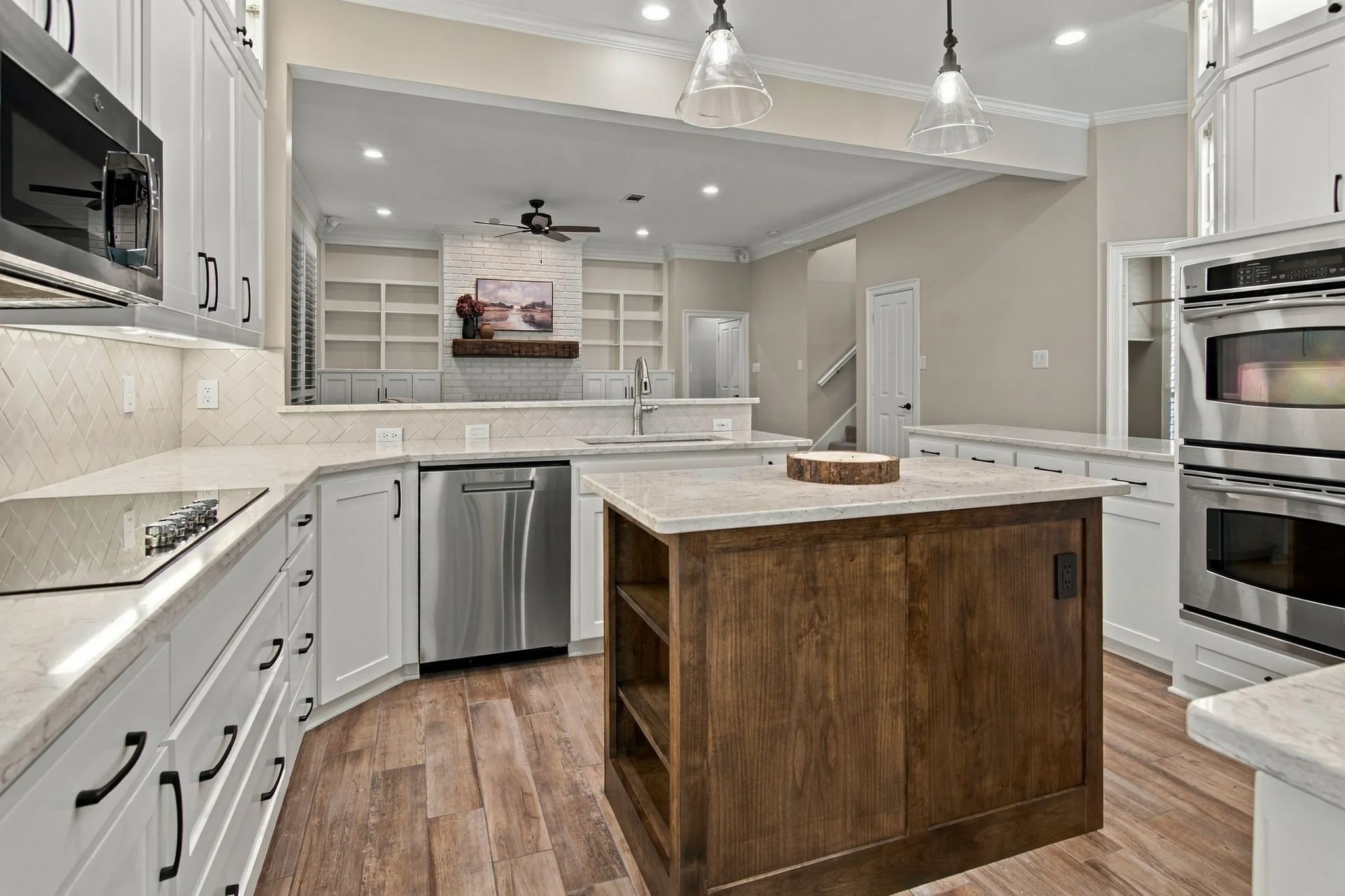 Gourmet kitchen featuring stainless steel appliances and sink, designer fixtures, double oven, wonderful storage, and beautiful lighting.  Electric cooktop but plumbed for gas cooking.