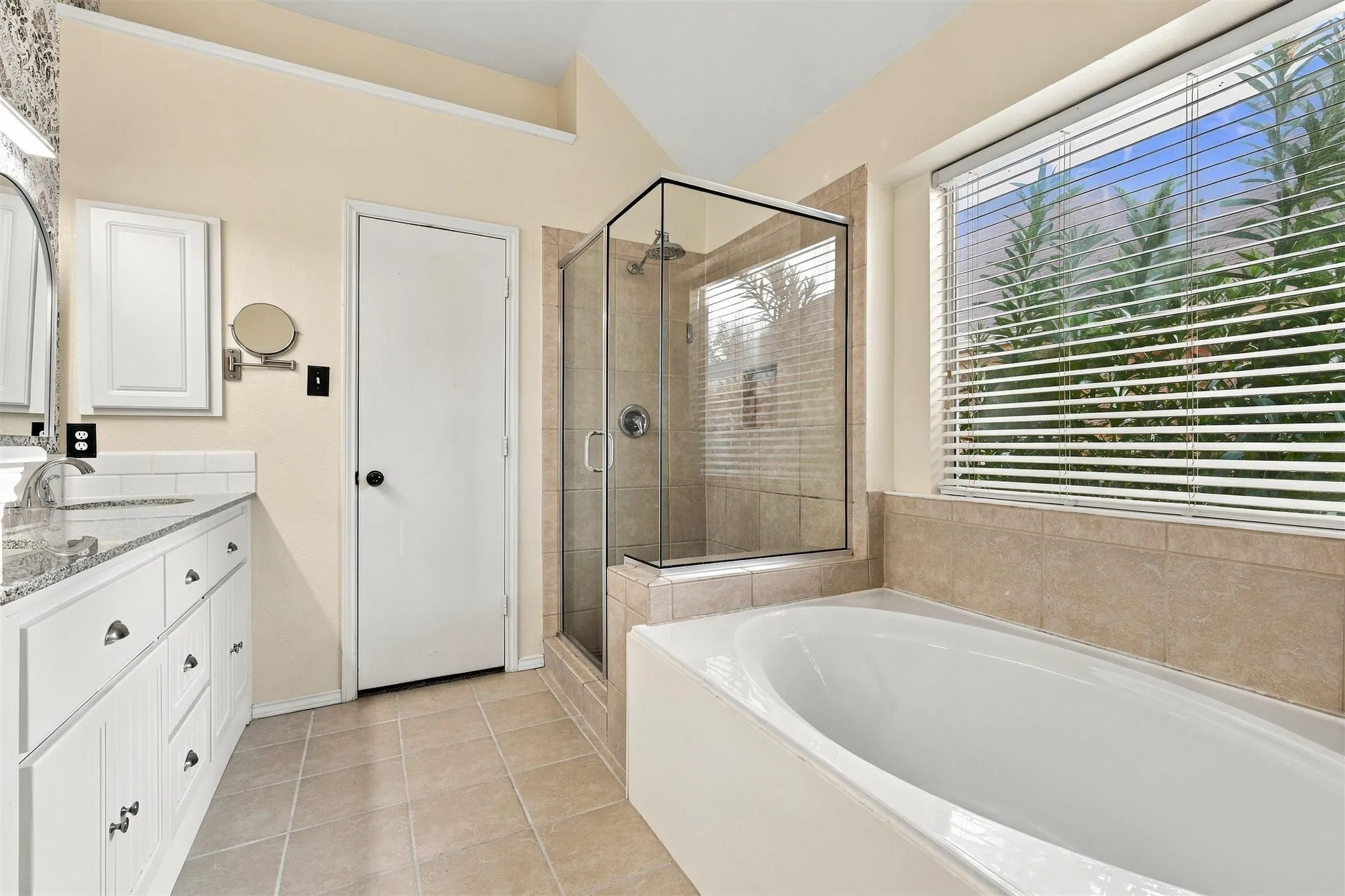 Double vanity with white cabinetry and granite-finish countertop