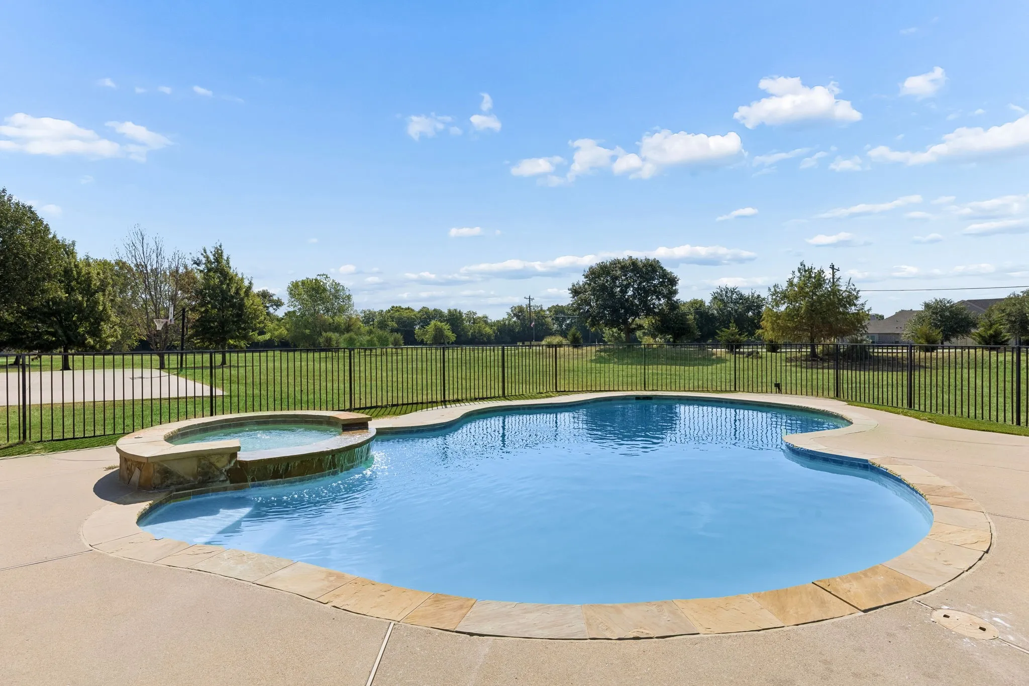 fenced in pool & spa with large backyard grass