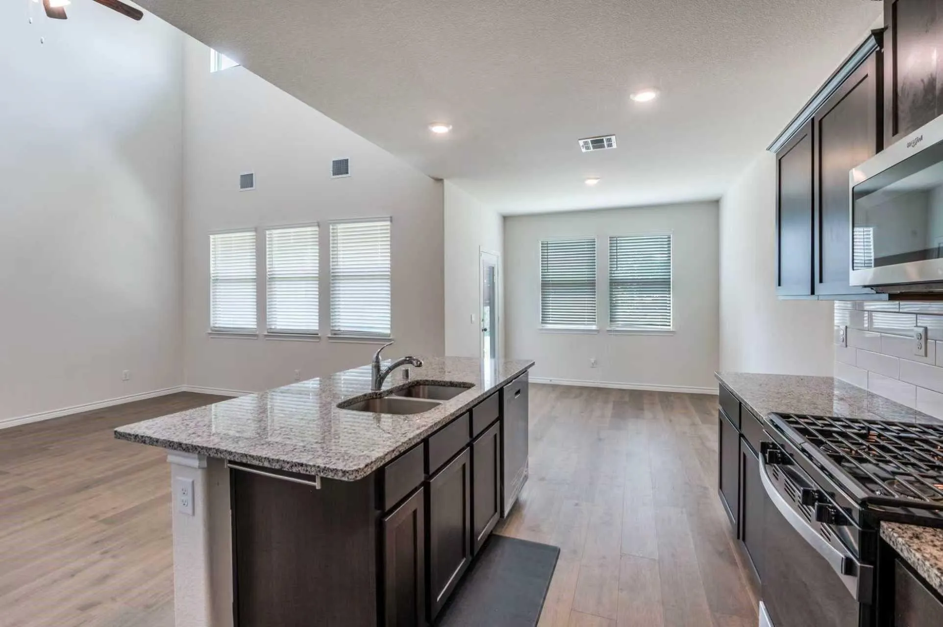 Kitchen island with granite countertop and double stainless steel sink