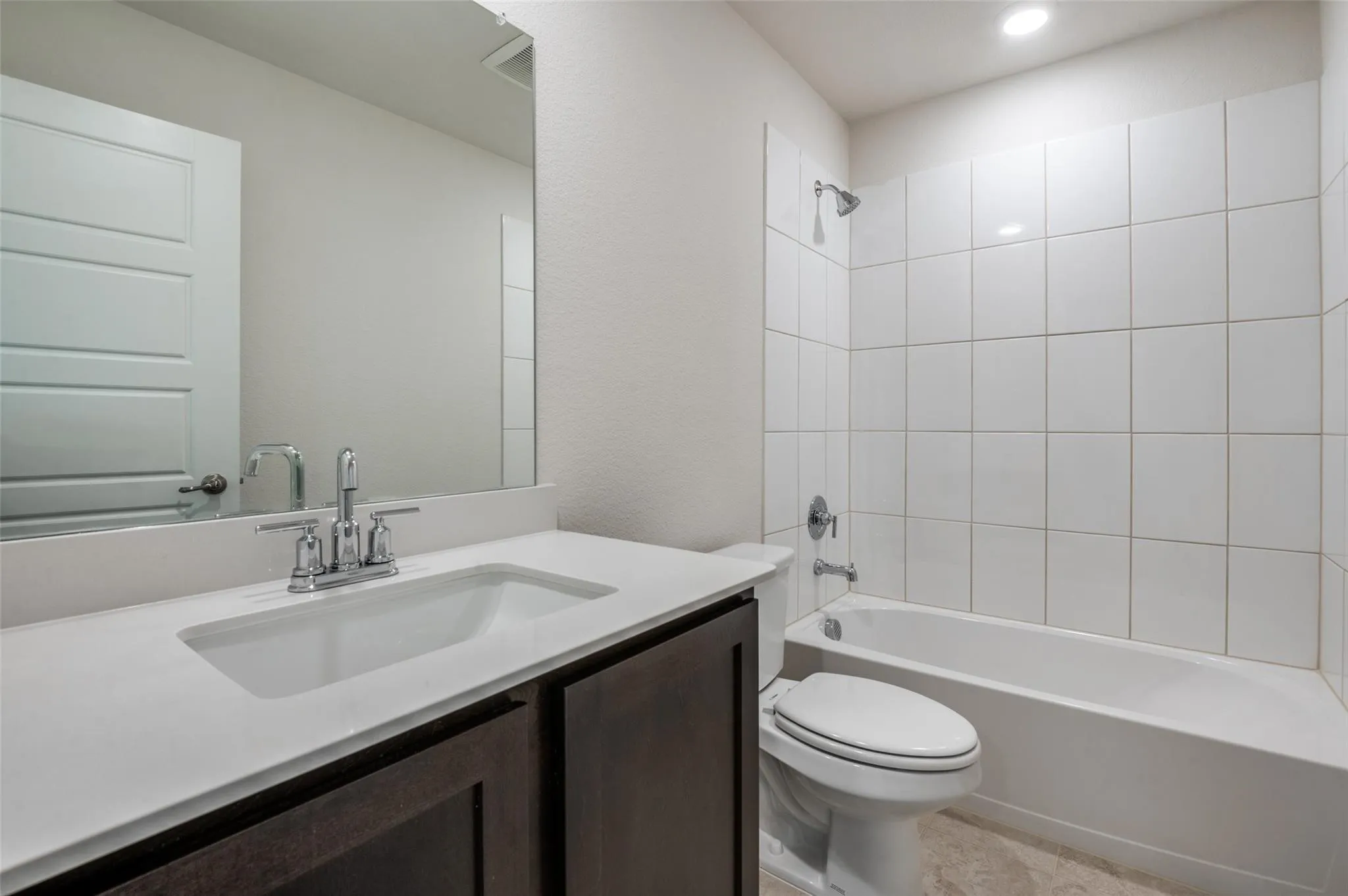 White subway tile shower surround with integrated bathtub