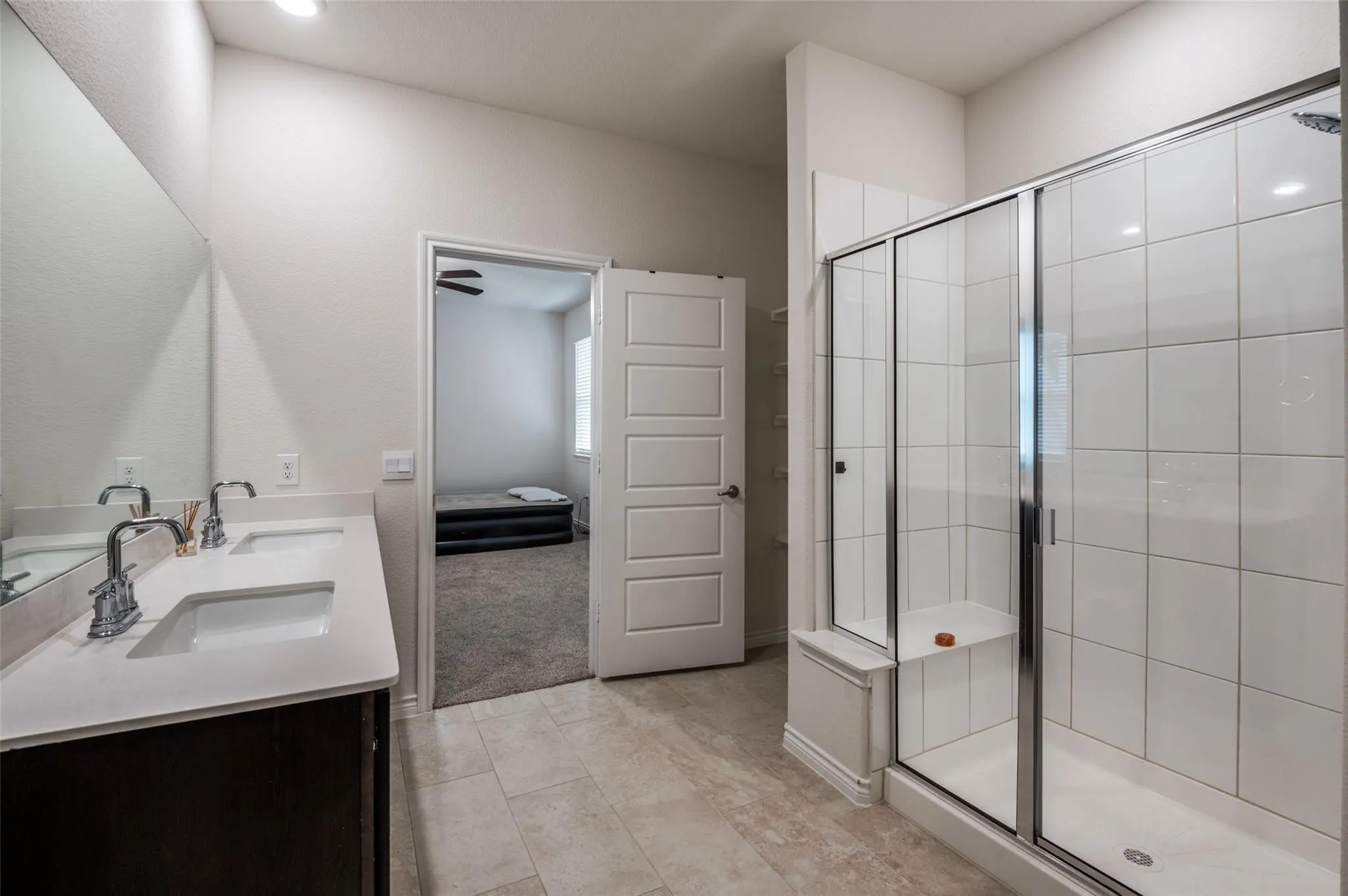 Dual vanity with undermount sinks, chrome fixtures, and a large wall-mounted mirror