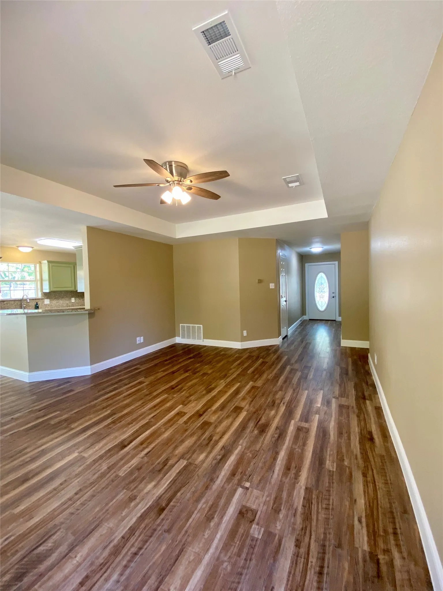 Wood-finish flooring throughout, recessed lighting, and a ceiling fan with light kit