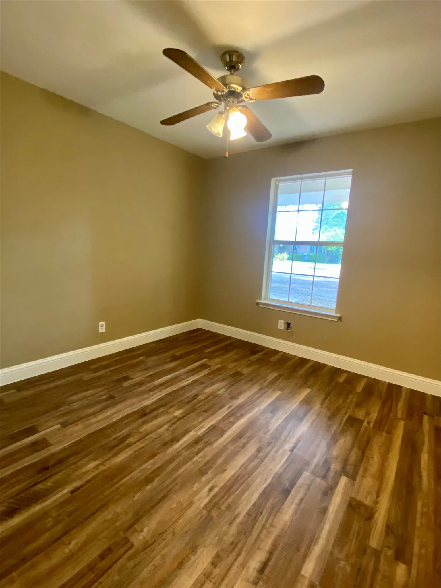 Bedroom #2 Wood-finish flooring with white trim
